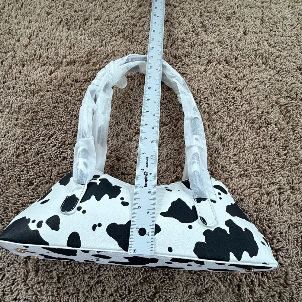 NWT new Anthropologie melie bianco east west shoulder bag cow print black white